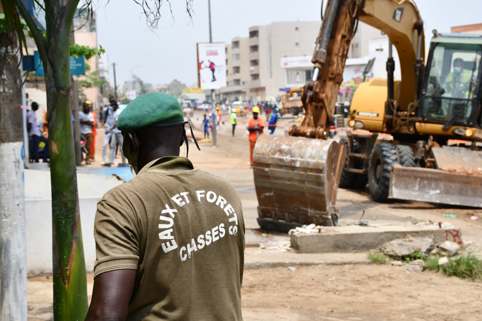 Agent des Eaux et Forêts observant une pelleteuse sur le chantier