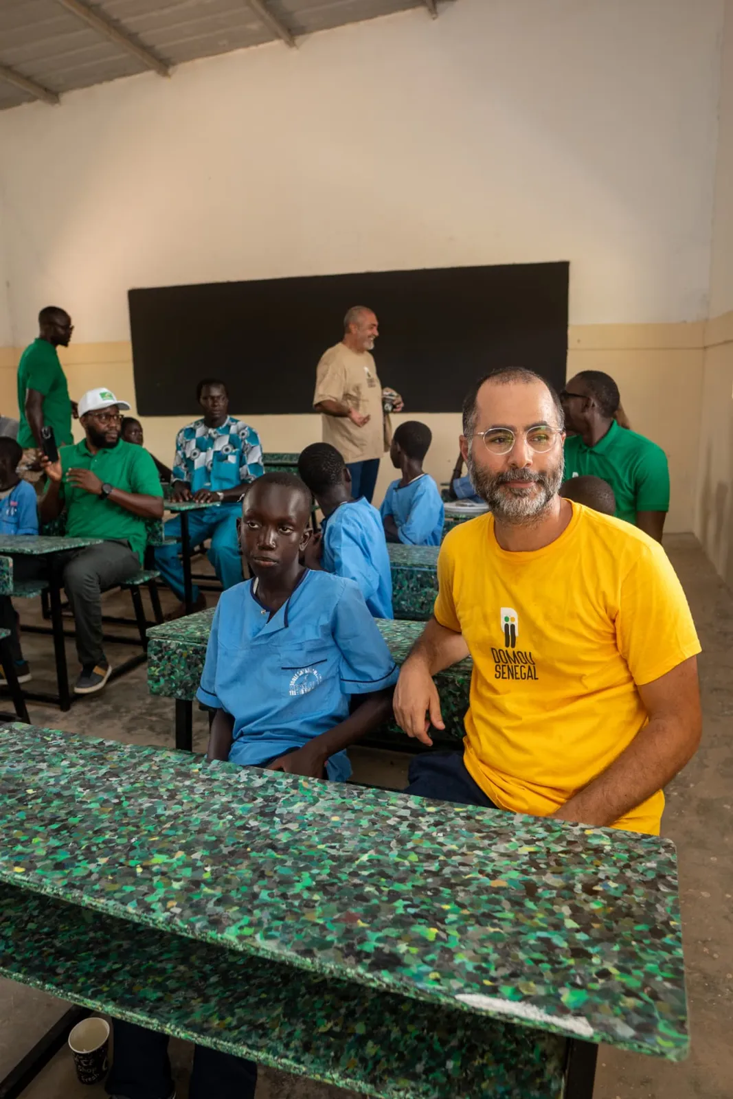Élève et membre de Domou Sénégal sur une table-banc Recuplast